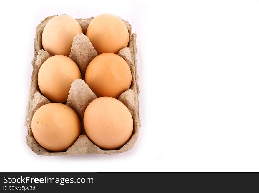 Brown eggs against a bright white background