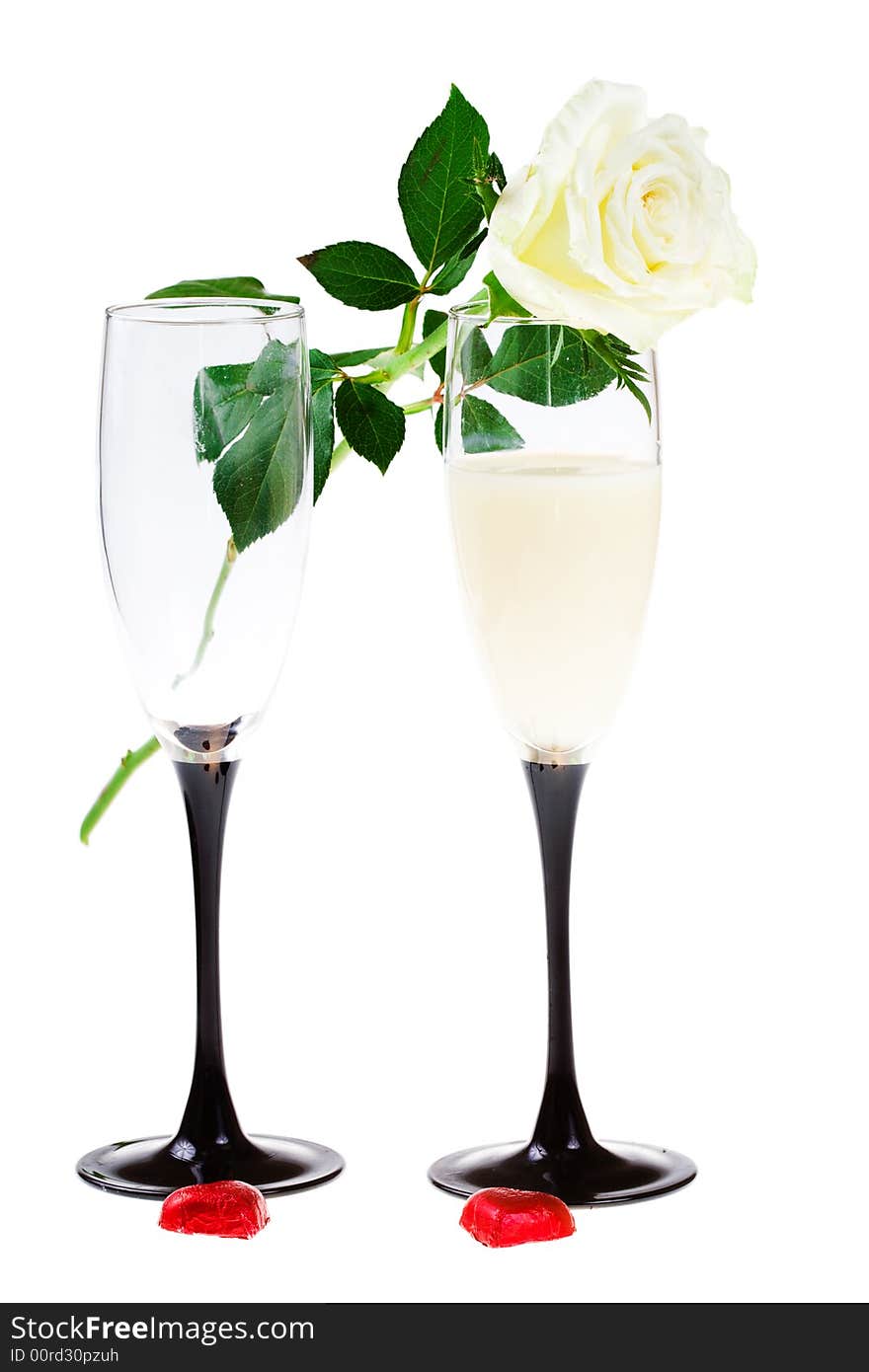 Two glasses with a rose and red hearts on a white background (isolated). Two glasses with a rose and red hearts on a white background (isolated)