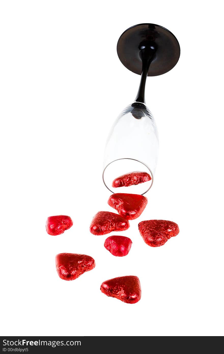 Glass and red hearts on a white background (isolated). Glass and red hearts on a white background (isolated)