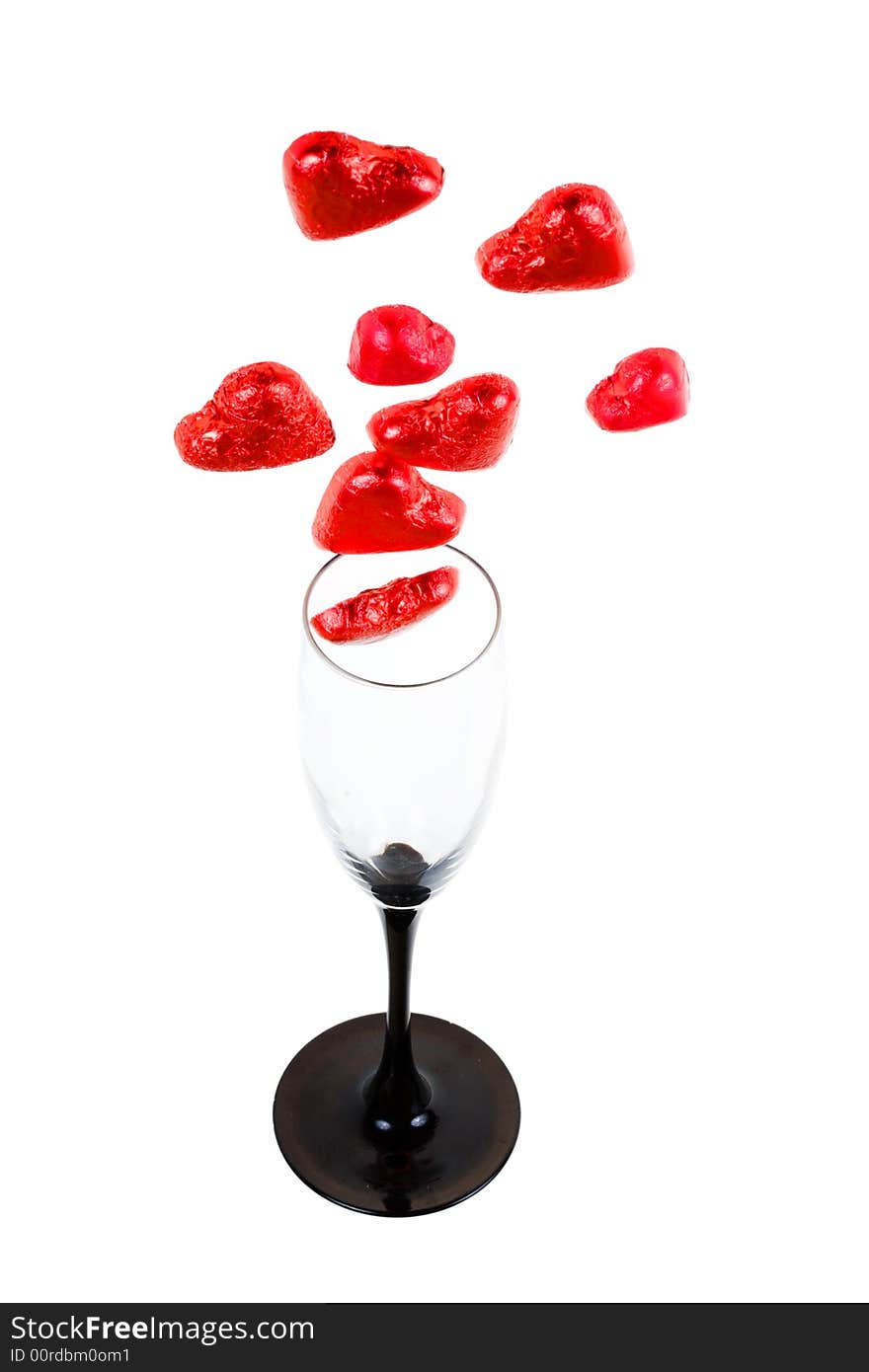 Glass and red hearts on a white background (isolated). Glass and red hearts on a white background (isolated)