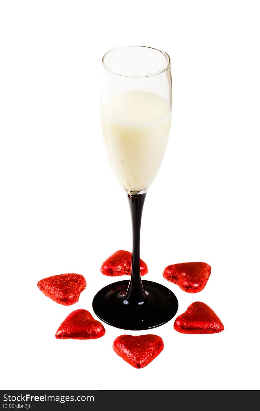 Glass with liquor and two red hearts (isolated). Glass with liquor and two red hearts (isolated)