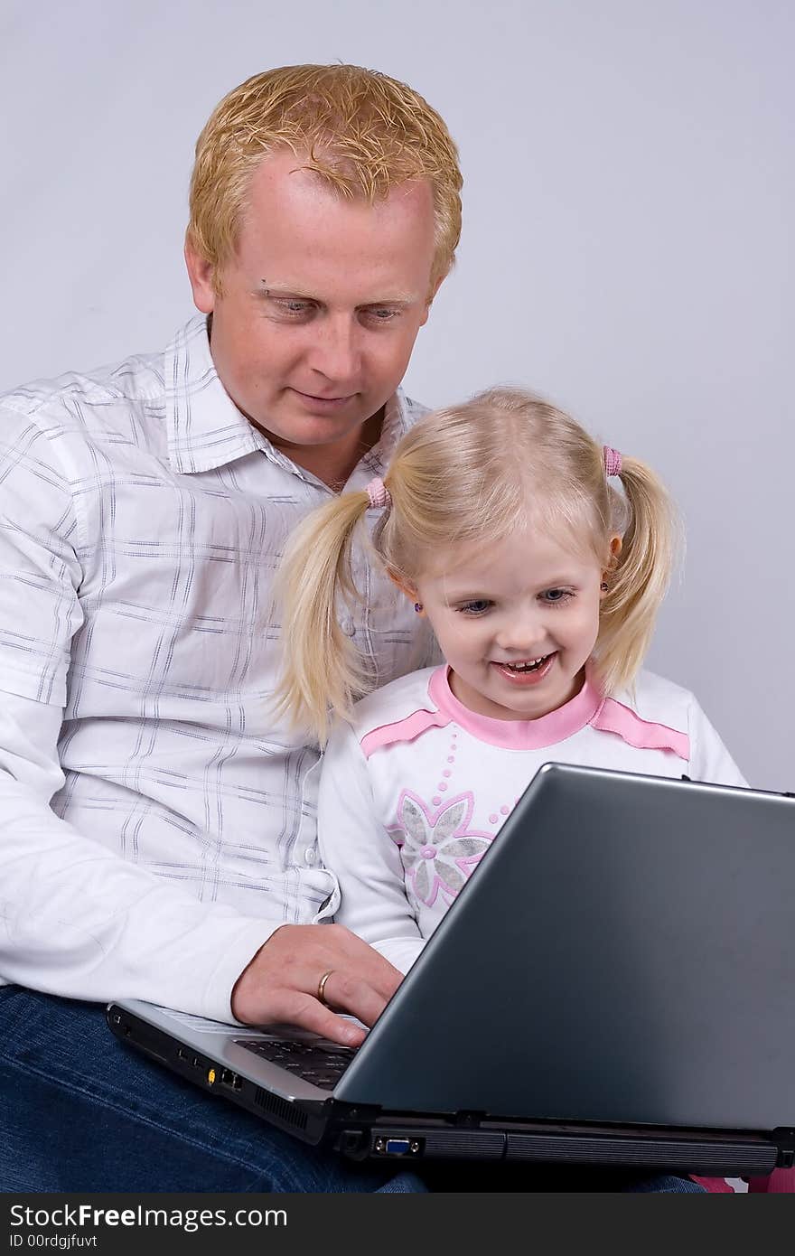 Father and daughter using laptop