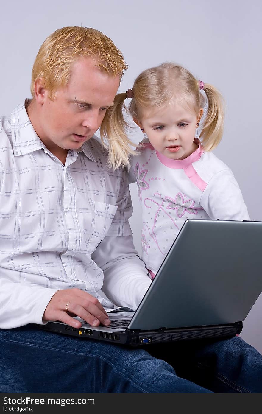 Father and daughter using laptop