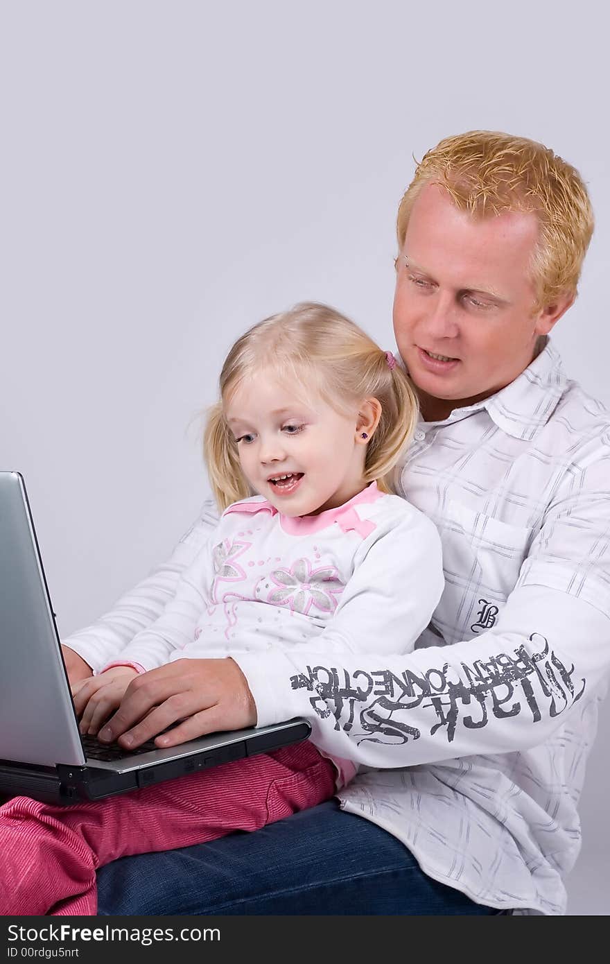 Father and daughter using laptop