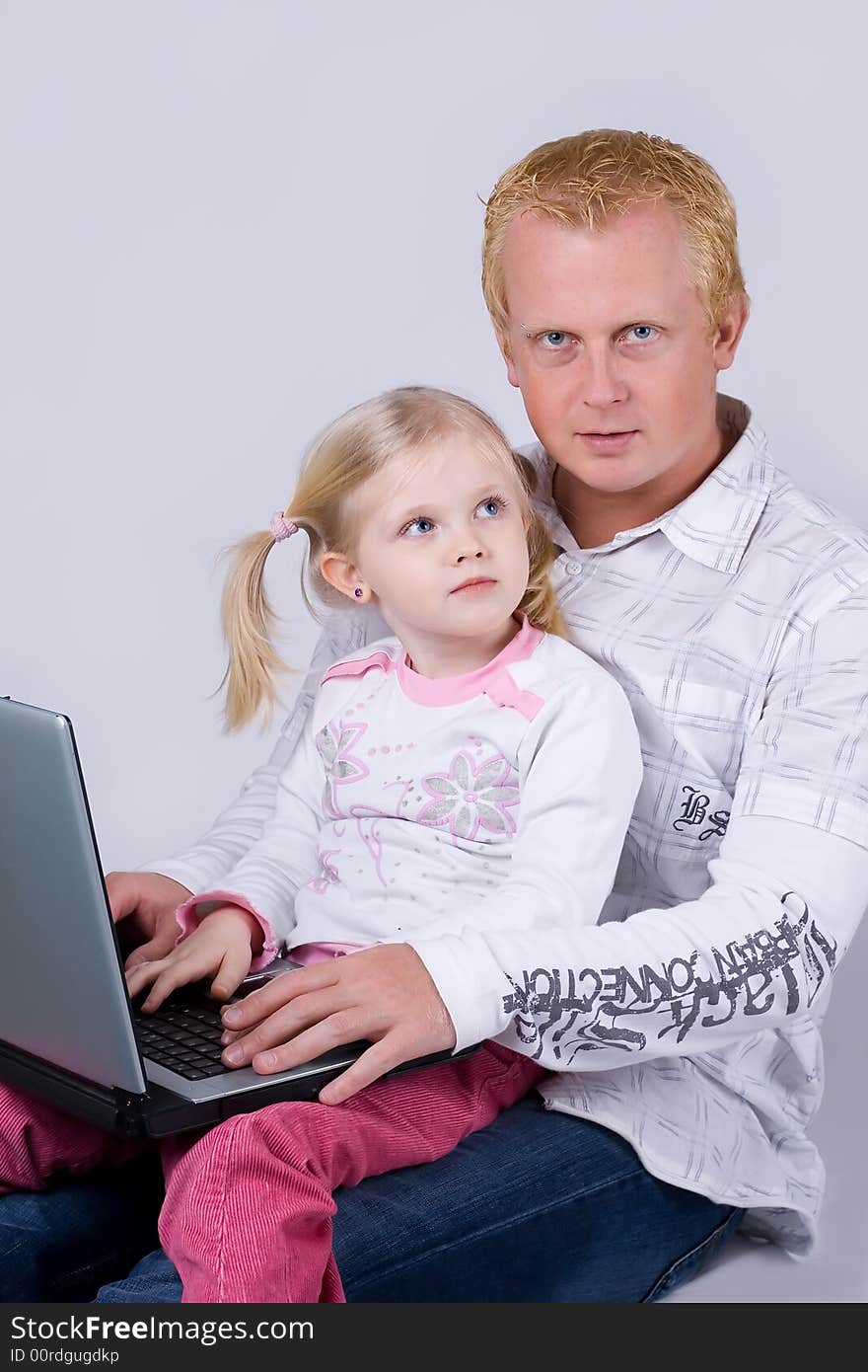 Father and daughter using laptop