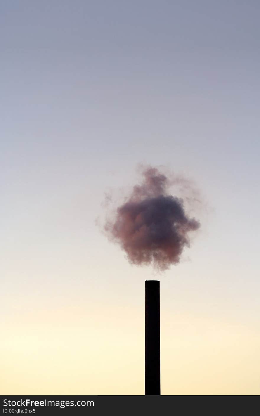 A chimney blowing purple haze in the sunset