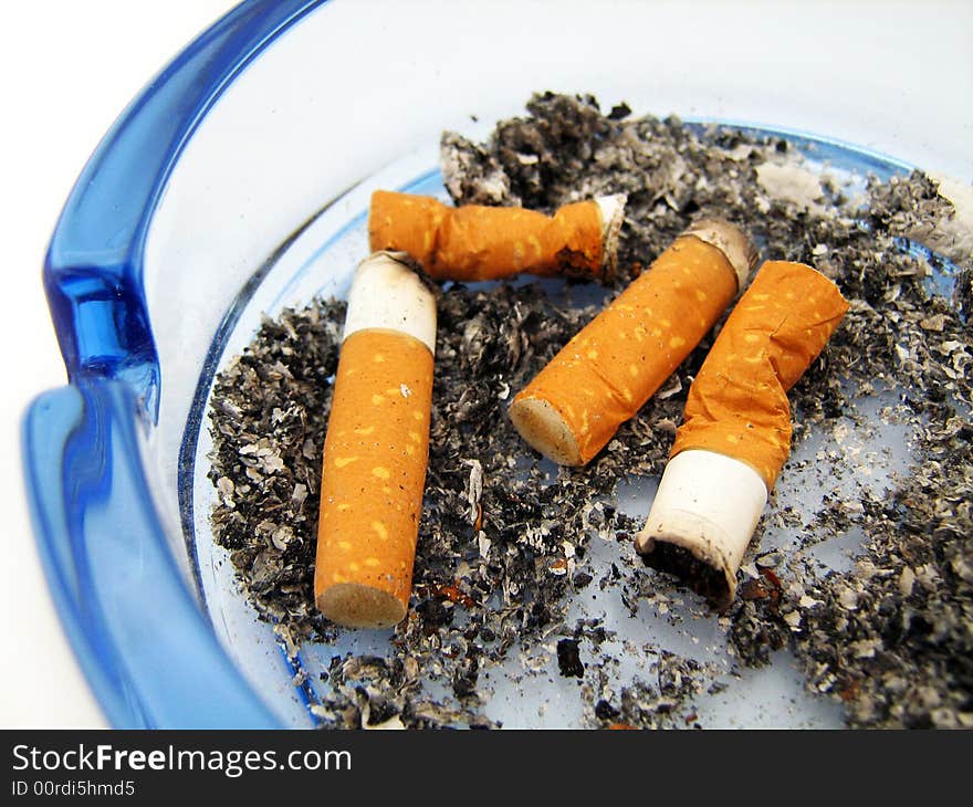 Blue glass ashtray with cigarette