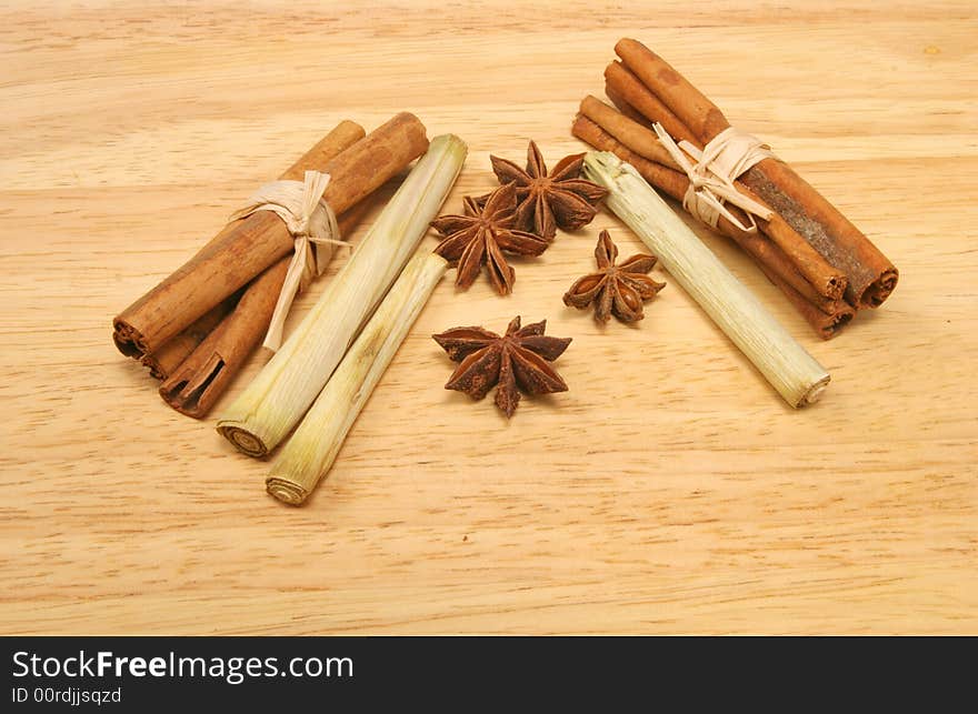 Cinnamon sticks star anise and lemon grass on a wooden background. Cinnamon sticks star anise and lemon grass on a wooden background