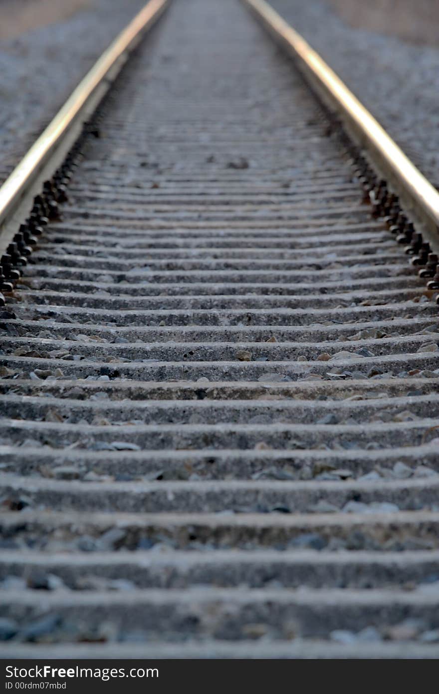 Detail of railroad tracks gleaming in the sunset