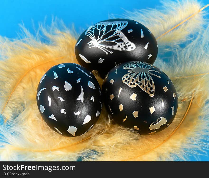 Easter egg with yellow feathers, hand-painted. Easter egg with yellow feathers, hand-painted