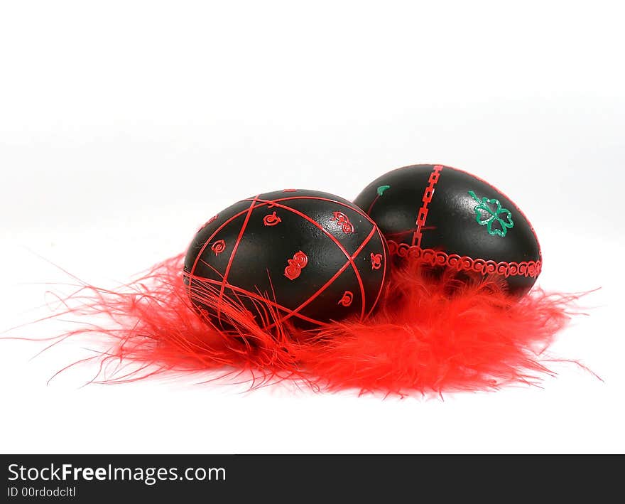 Easter eggs with red feathers, hand-painted