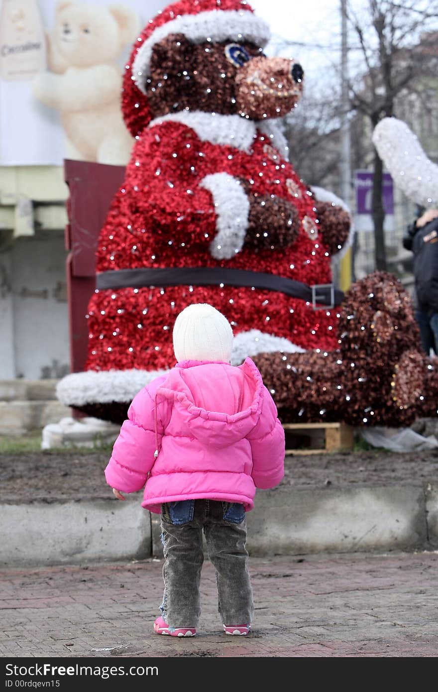 A little cute girl looking at the Santa