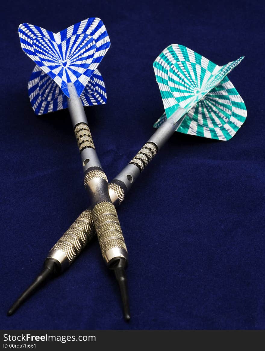 Blue and green darts on blue background. Blue and green darts on blue background