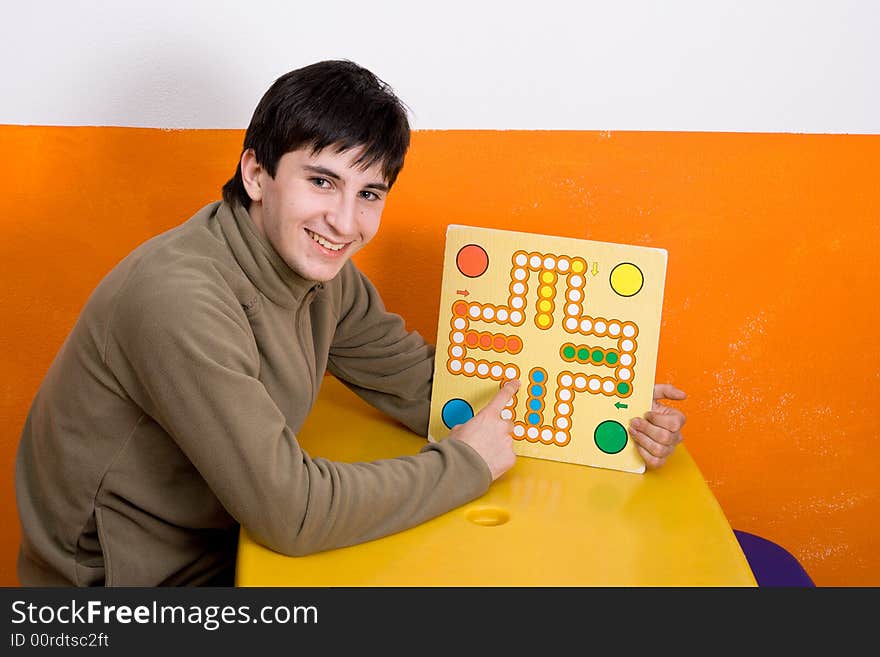 The happy boy with a board game. The happy boy with a board game