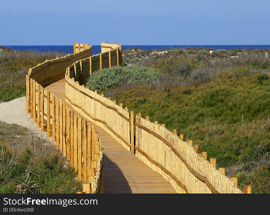 A quiet pathway leads to a beautiful beach. Sardinia beach.