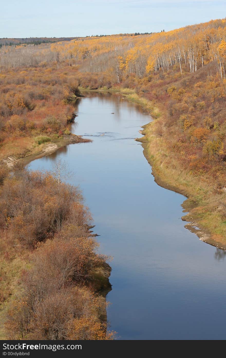 Beaver River bordered by fall foliage.