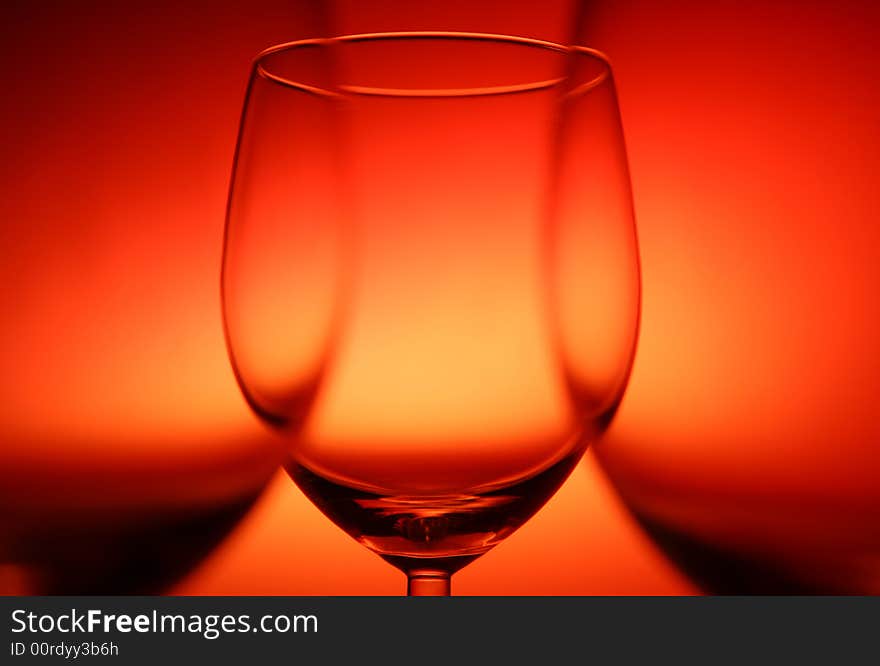 Three empty glasses on red background