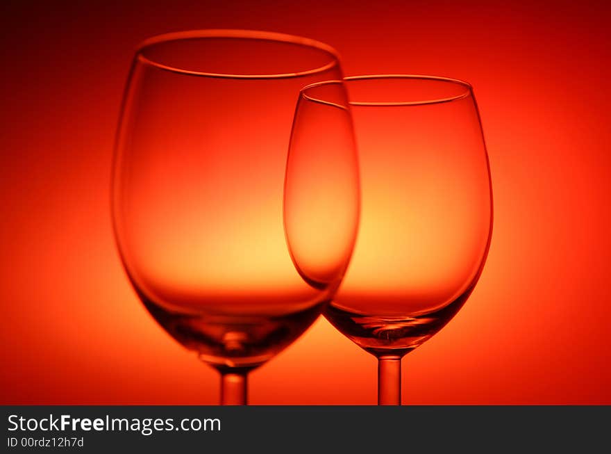 Two empty glasses on red background