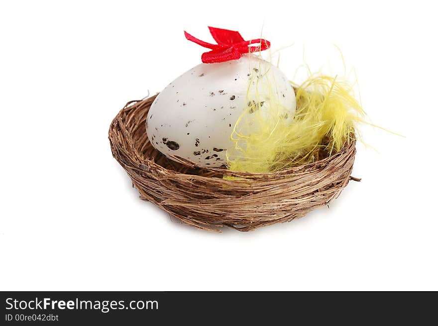 Nest with  decorative egg inside on white background. Nest with  decorative egg inside on white background