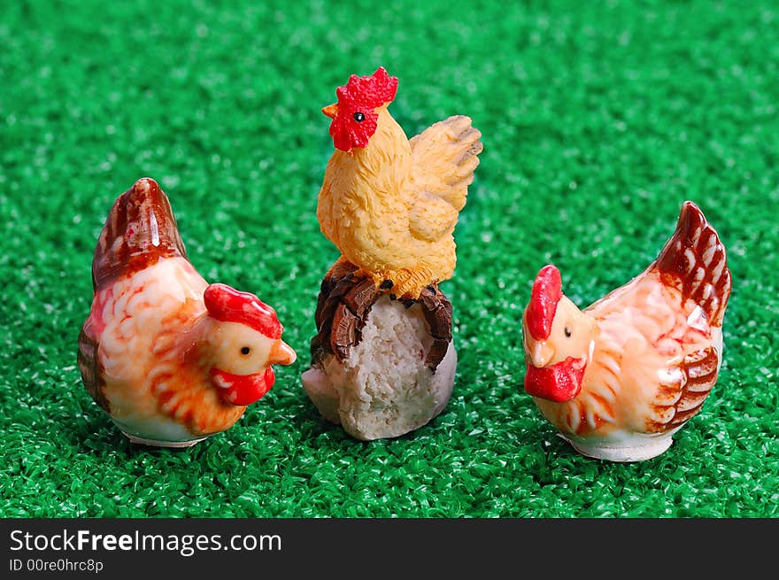 Easter decoration - two hens and rooster on green