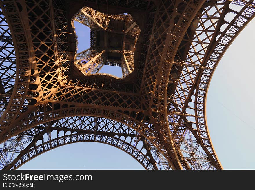 The Eiffel Tower is an iron tower built on the Champ de Mars beside the River Seine in Paris. The tower has become a global icon of France and is one of the most recognizable structures in the world.