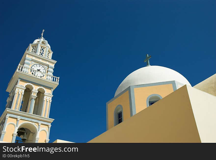 Leaning clock tower and church in Santorini