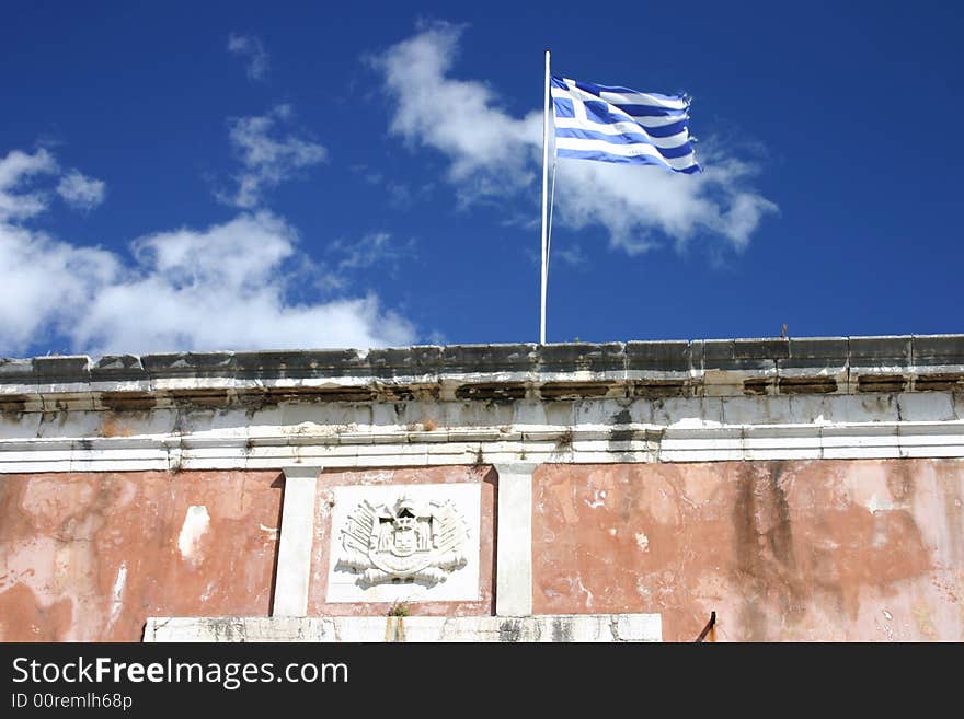 Greek flag in front of old fortress in Corfu town, Greece