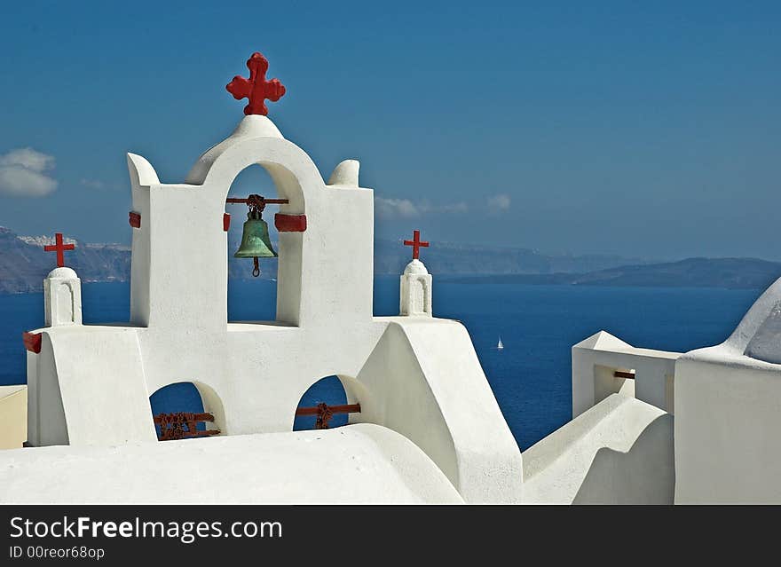 A whitewashed, belltower overlooking the Aegean sea. A whitewashed, belltower overlooking the Aegean sea