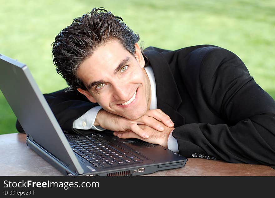 Confident and successful young adult businessman working on his laptop computer