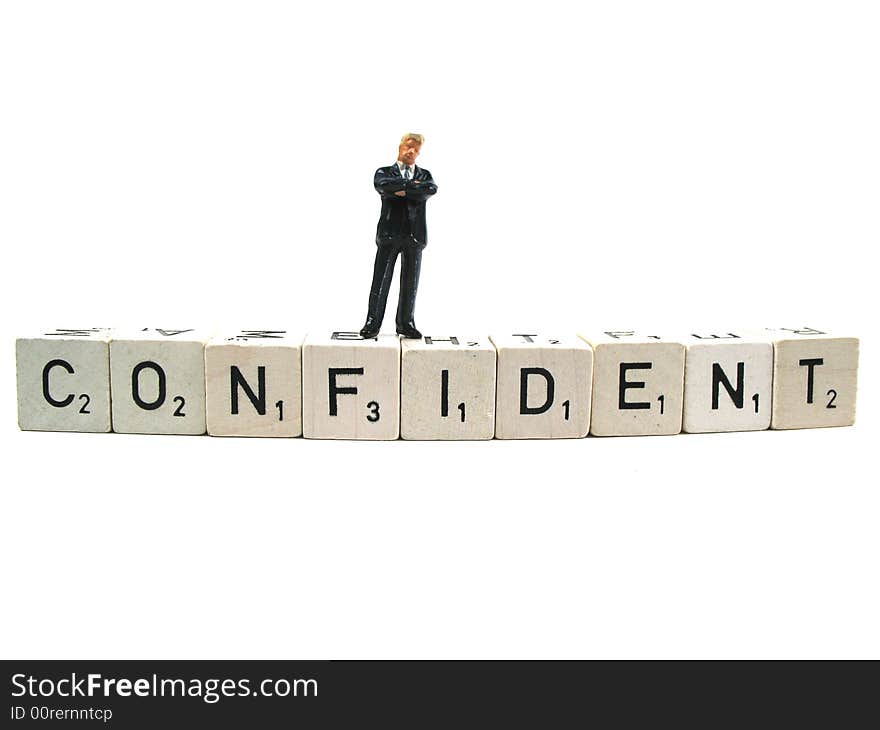 A confident businessman standing on the word confident