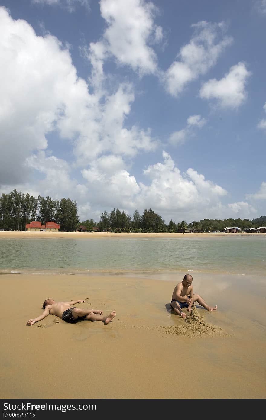 Adults Playing with the Sand on the Beach. Adults Playing with the Sand on the Beach