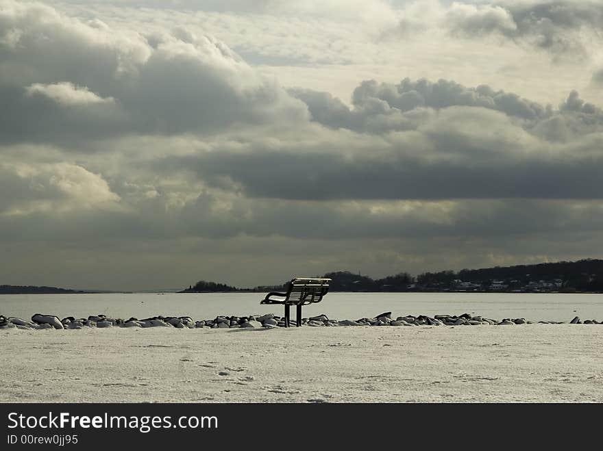 Bench commands view of Narragansett Bay under heavy clouds. Bench commands view of Narragansett Bay under heavy clouds