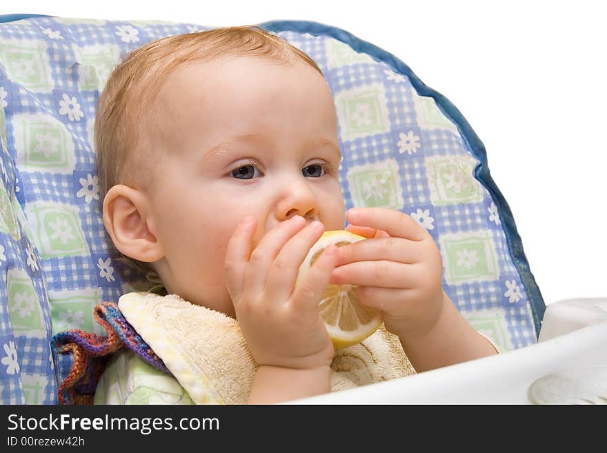 Baby eating lemon on the isolated background