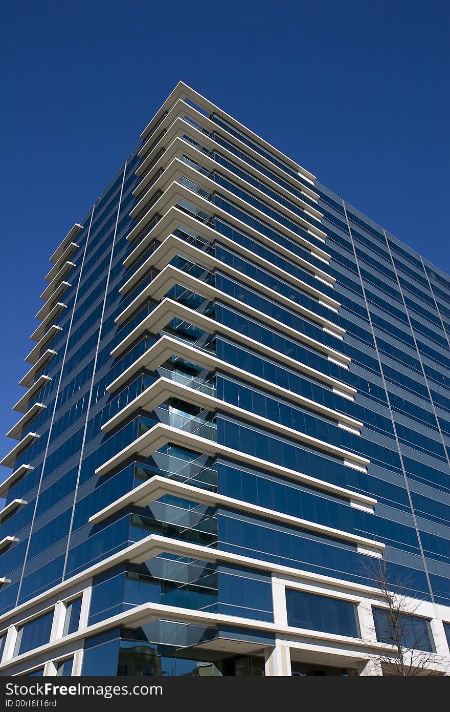 A blue glass office building with white corners. A blue glass office building with white corners