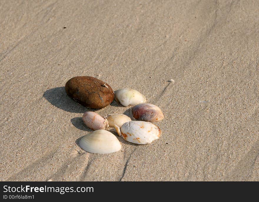 Pebbles on the sand on a hot sunny day