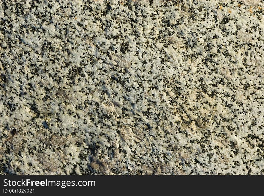 Detail of a variegated black and white granite stone, great background. Detail of a variegated black and white granite stone, great background