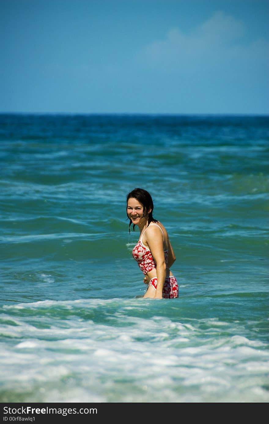 Woman in a red bikini on a tropical beach. Woman in a red bikini on a tropical beach