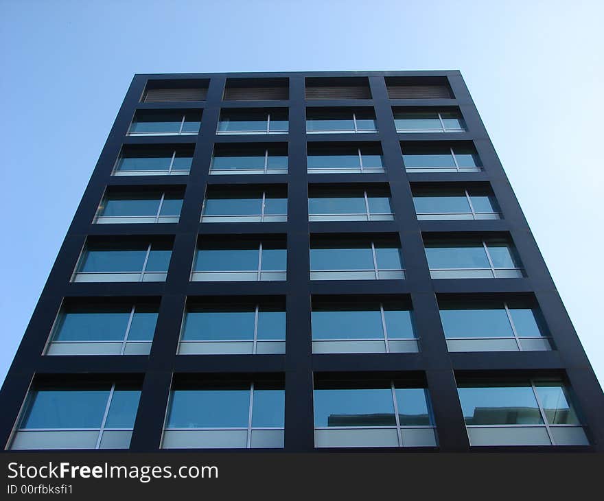 Tall office building with a blue sky as a background