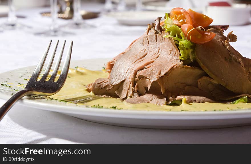 Beef meat with tomatoes and greens on a plate