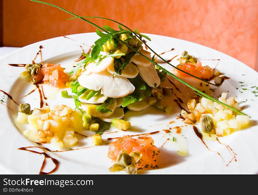 Plate with meat, greens, corn, pineapples, nuts an