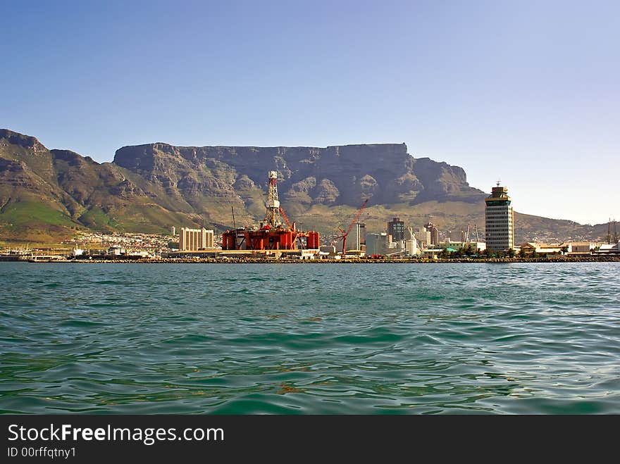 Panorama of city of cape town from the bay oil rig near tower building against table mountain