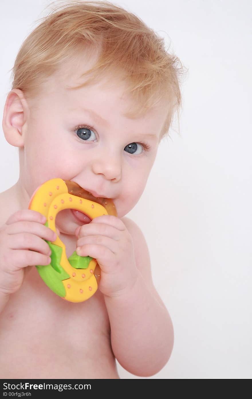 Portrait of the beautiful fair-haired boy with a toy in hands. Portrait of the beautiful fair-haired boy with a toy in hands