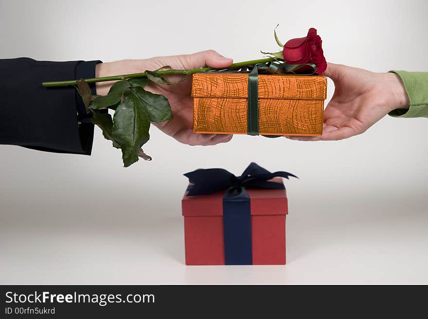 An exchange of gift between a couple, businessmen/woman. An exchange of gift between a couple, businessmen/woman