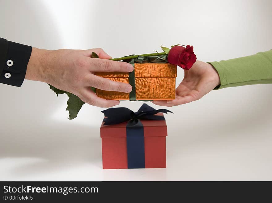 An exchange of gift between a couple, businessmen/woman. An exchange of gift between a couple, businessmen/woman