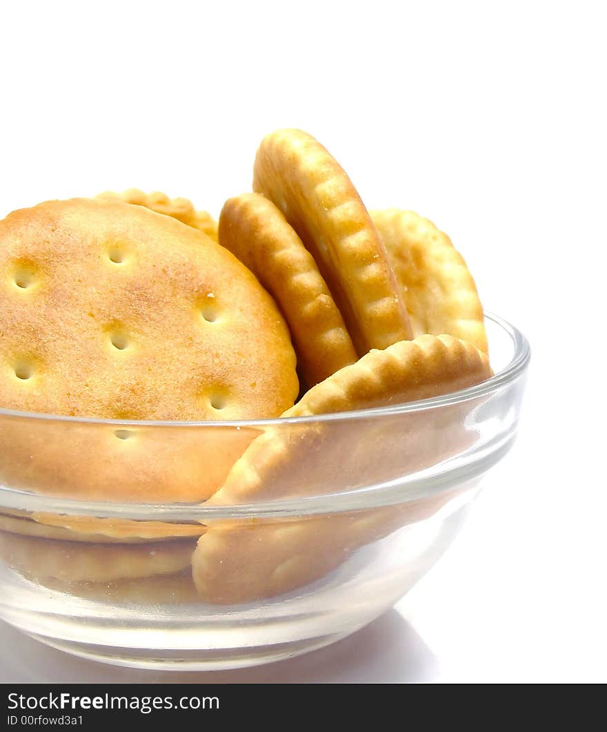 Salt crackers food  in the glass vase isolated over white background. Salt crackers food  in the glass vase isolated over white background