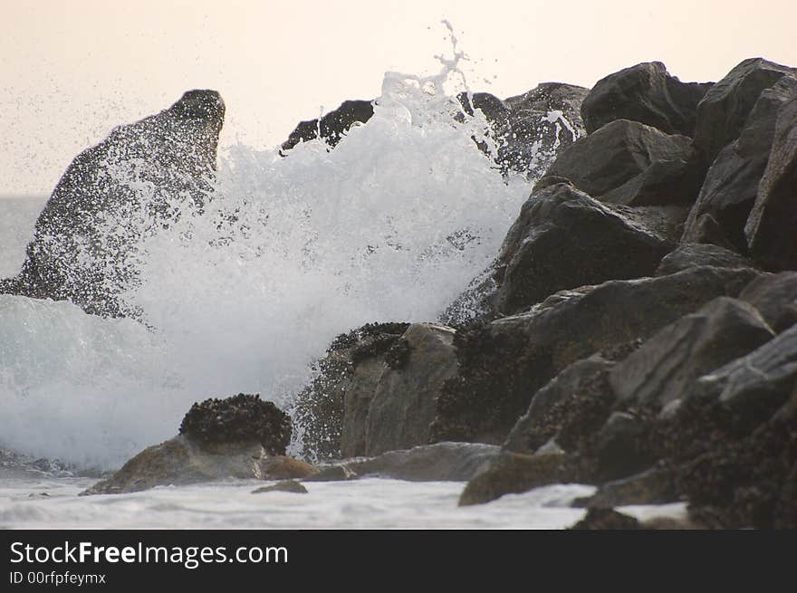 Strong waves crashing against the rocks on the famous New Port Beach, CA. Strong waves crashing against the rocks on the famous New Port Beach, CA.