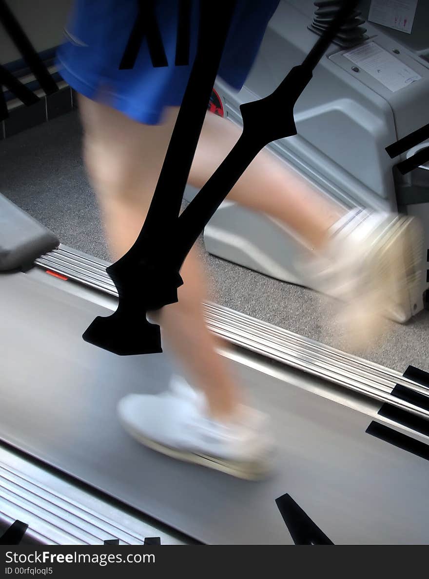 Young male running on treadmill in gymnasium. Young male running on treadmill in gymnasium