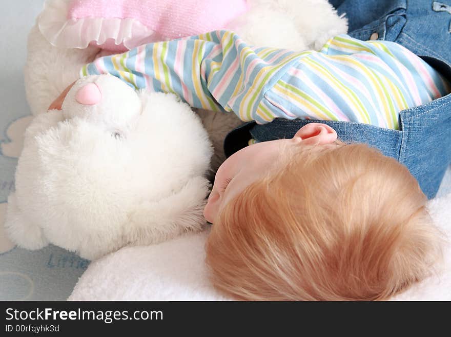 The small beautiful boy sleeps a head on a pillow. The small beautiful boy sleeps a head on a pillow