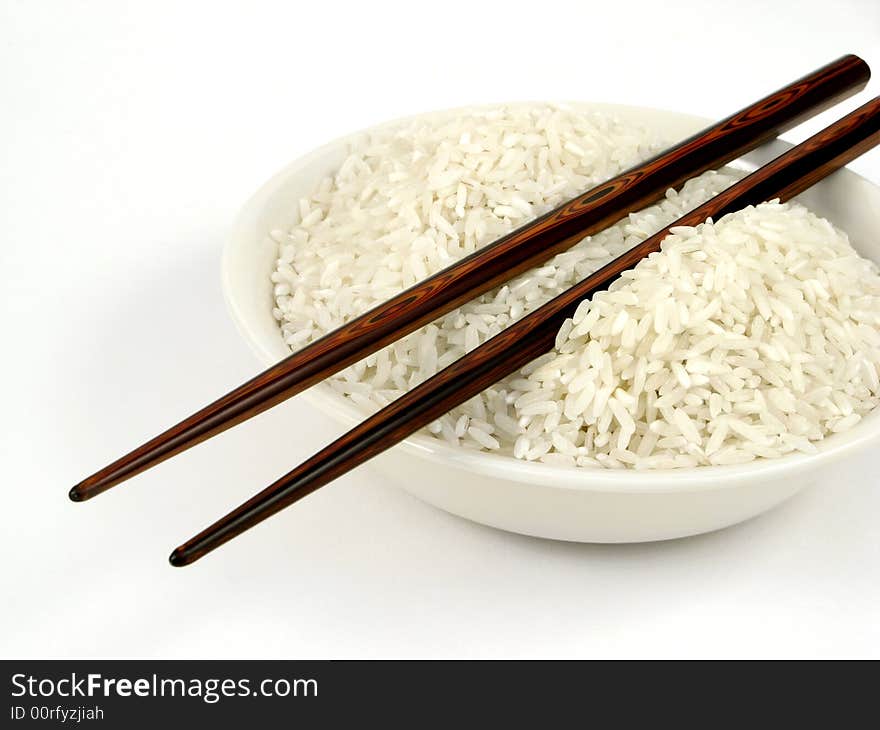 Uncook White Rice In Bowl With Chop Sticks