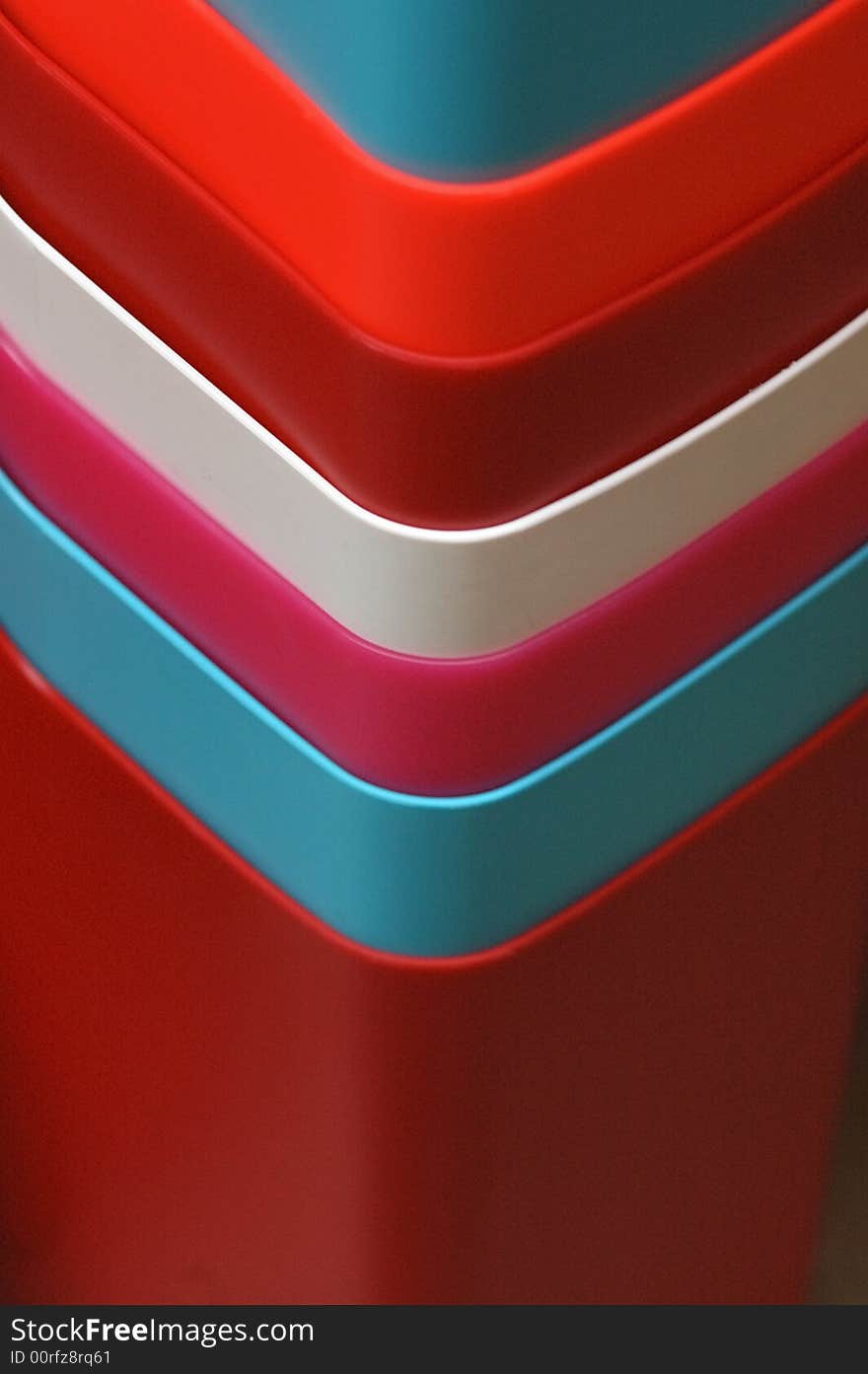 This is a photograph of colorful bins for sale in a marketplace.  This photograph shows bins in red, blue and white color for sale.